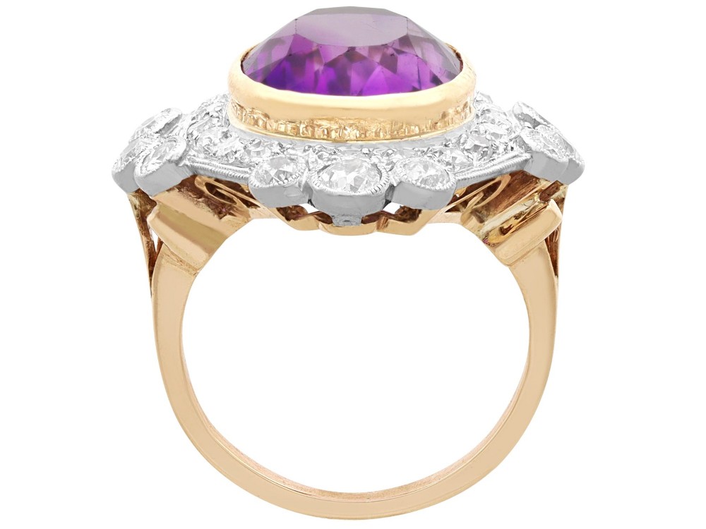 An Art Deco ring featuring a central oval purple amethyst set in yellow gold, framed by a millegrain diamond halo. View VIII
