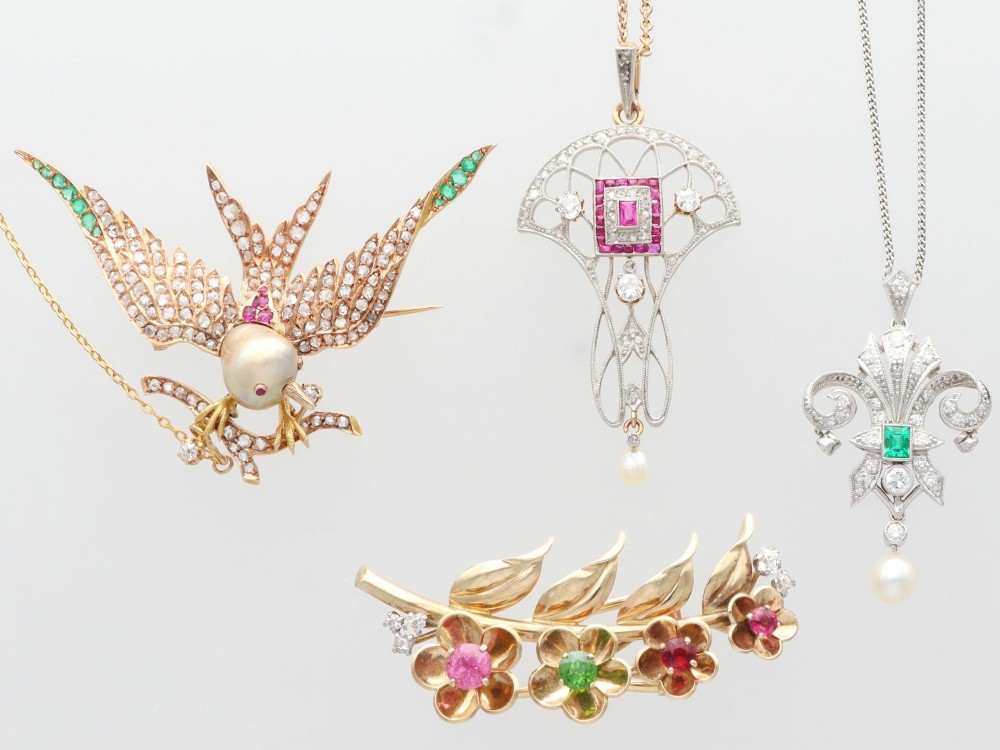 An Edwardian openwork yellow gold pendant set with a central square-cut ruby surrounded by small rubies, diamonds, and a suspended natural pearl drop. View VII