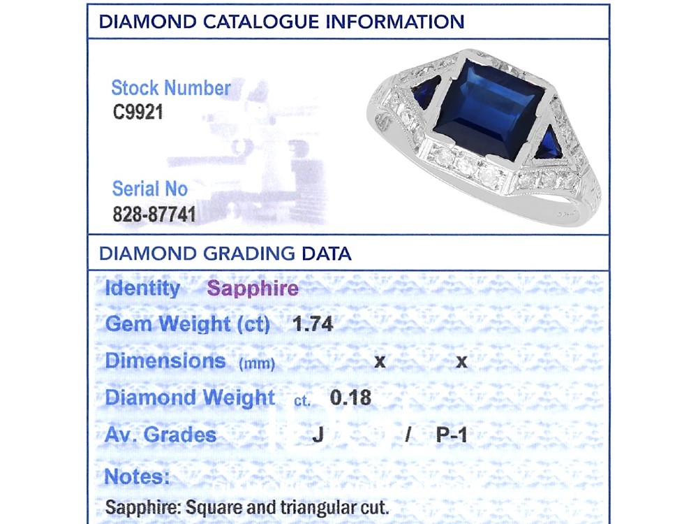 An Art Deco platinum ring featuring a central rectangular step-cut blue sapphire flanked by triangular sapphires and diamond-set shoulder details. View IX