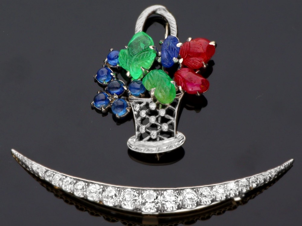 An antique crescent-shaped brooch set with a row of graduated diamonds mounted in gold and silver. View VI