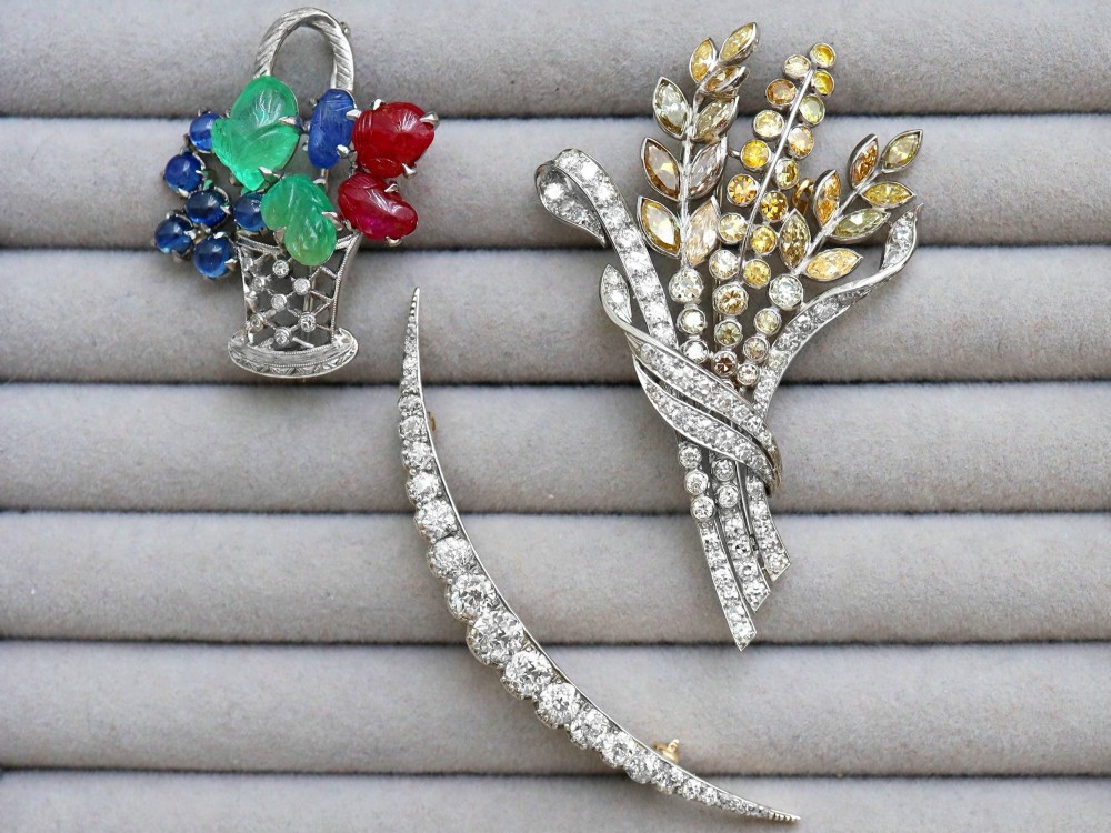 An antique crescent-shaped brooch set with a row of graduated diamonds mounted in gold and silver. View VII
