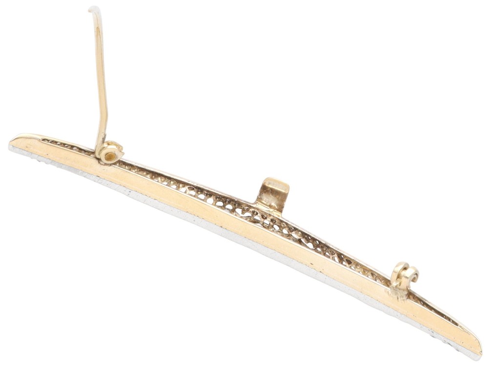 An antique crescent-shaped brooch set with a row of graduated diamonds mounted in gold and silver. View X