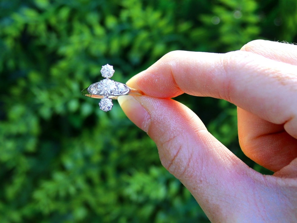 An antique 18ct yellow gold ring featuring five old-cut diamonds set in a geometric white metal arrangement. View II
