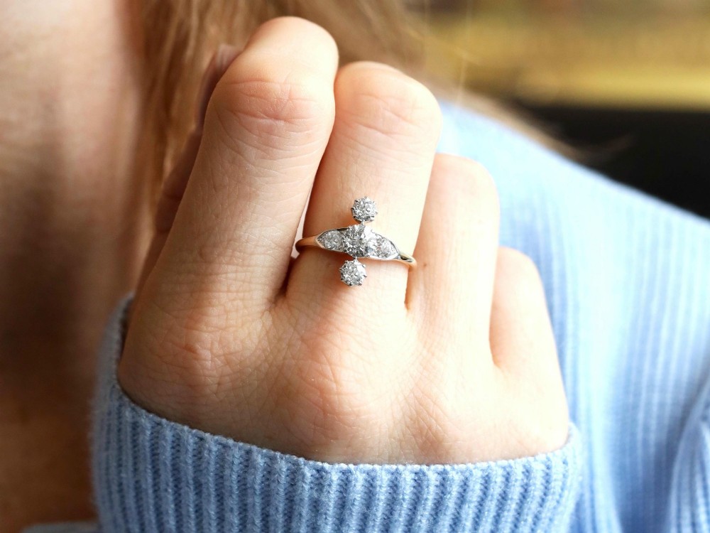 An antique 18ct yellow gold ring featuring five old-cut diamonds set in a geometric white metal arrangement. View IV