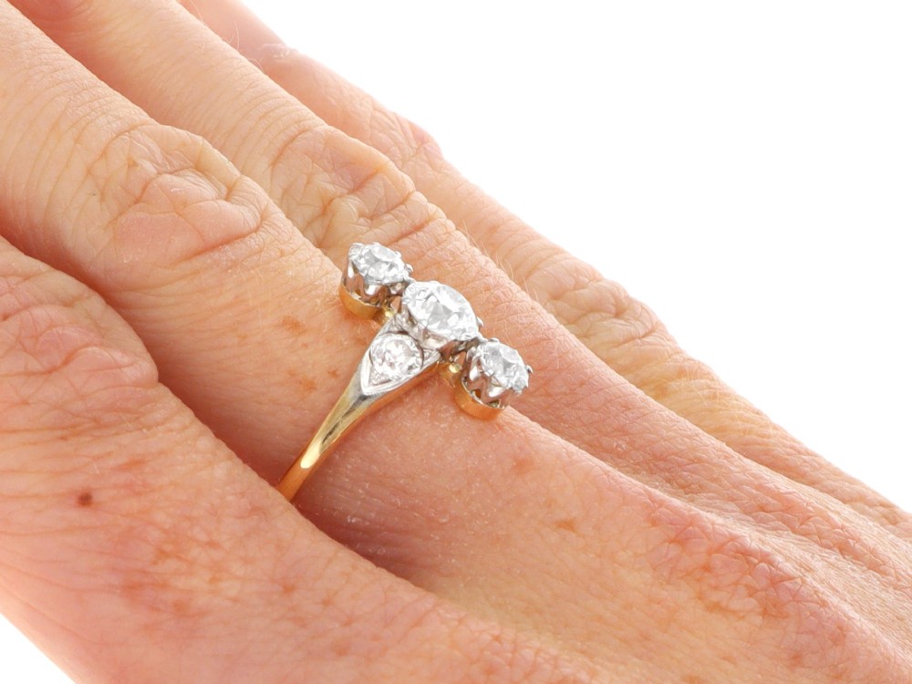 An antique 18ct yellow gold ring featuring five old-cut diamonds set in a geometric white metal arrangement. View XI