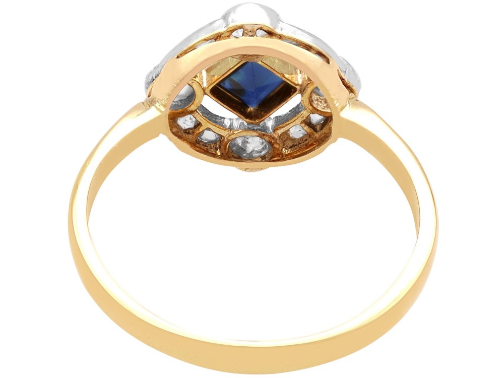 An 18ct yellow gold ring featuring a central square blue sapphire surrounded by an openwork diamond-set frame. View VI
