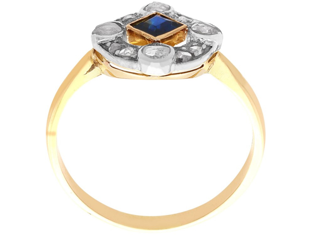 An 18ct yellow gold ring featuring a central square blue sapphire surrounded by an openwork diamond-set frame. View VII