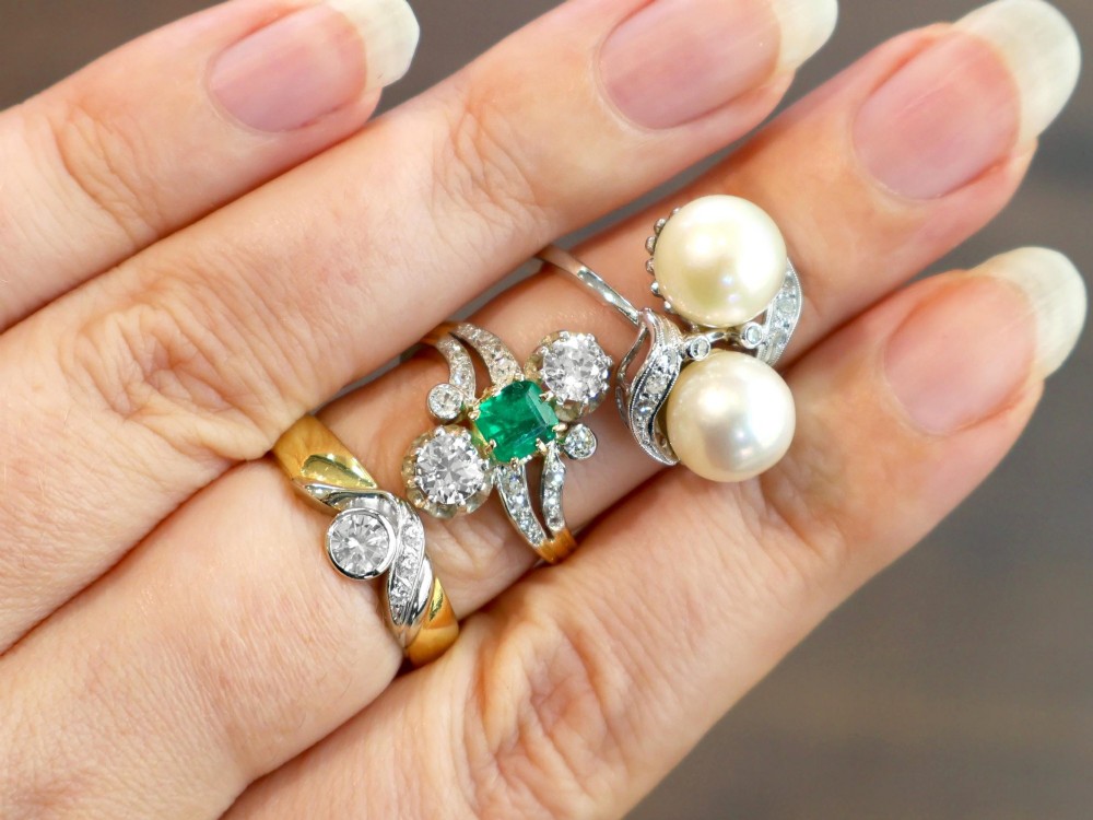 A circa 1950 white gold crossover cocktail ring featuring two cultured pearls flanked by diamond-accented bypass shoulders. View V