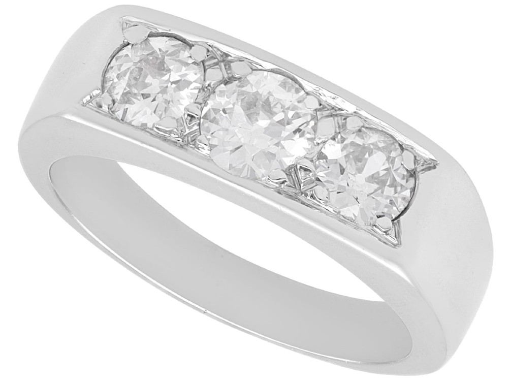 An 18ct white gold Art Deco trilogy ring featuring three round diamonds set horizontally across a wide band.