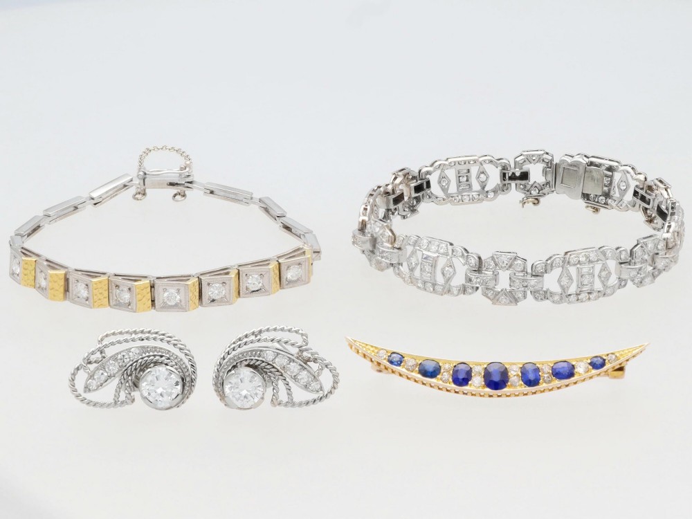 An Art Deco two-tone 18ct gold and white metal link bracelet featuring square diamond-set panels alternating with textured gold links. View VI