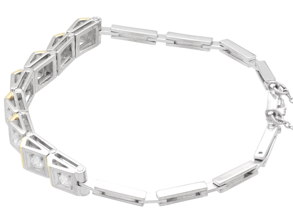 An Art Deco two-tone 18ct gold and white metal link bracelet featuring square diamond-set panels alternating with textured gold links. View VIII