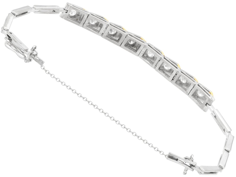 An Art Deco two-tone 18ct gold and white metal link bracelet featuring square diamond-set panels alternating with textured gold links. View IX