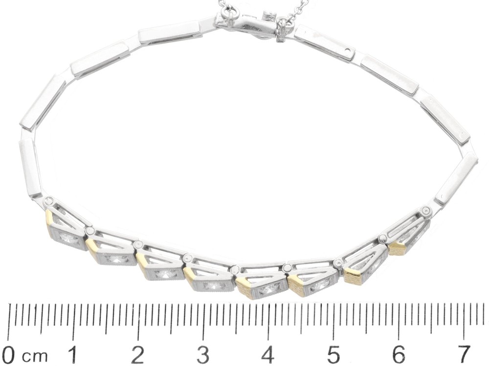 An Art Deco two-tone 18ct gold and white metal link bracelet featuring square diamond-set panels alternating with textured gold links. View X
