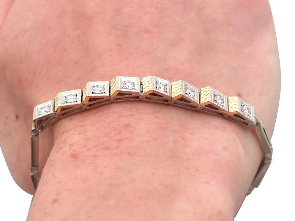 An Art Deco two-tone 18ct gold and white metal link bracelet featuring square diamond-set panels alternating with textured gold links. View XIV