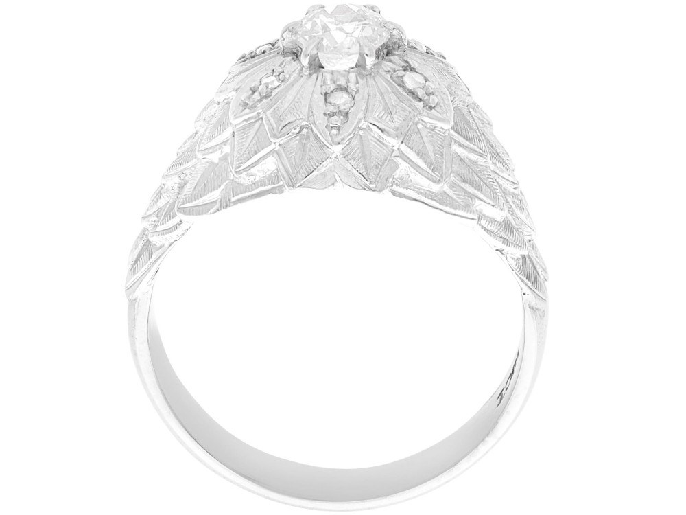 An Art Deco 18ct white gold dress ring with engraved floral textured petals and a central diamond accent. View VII