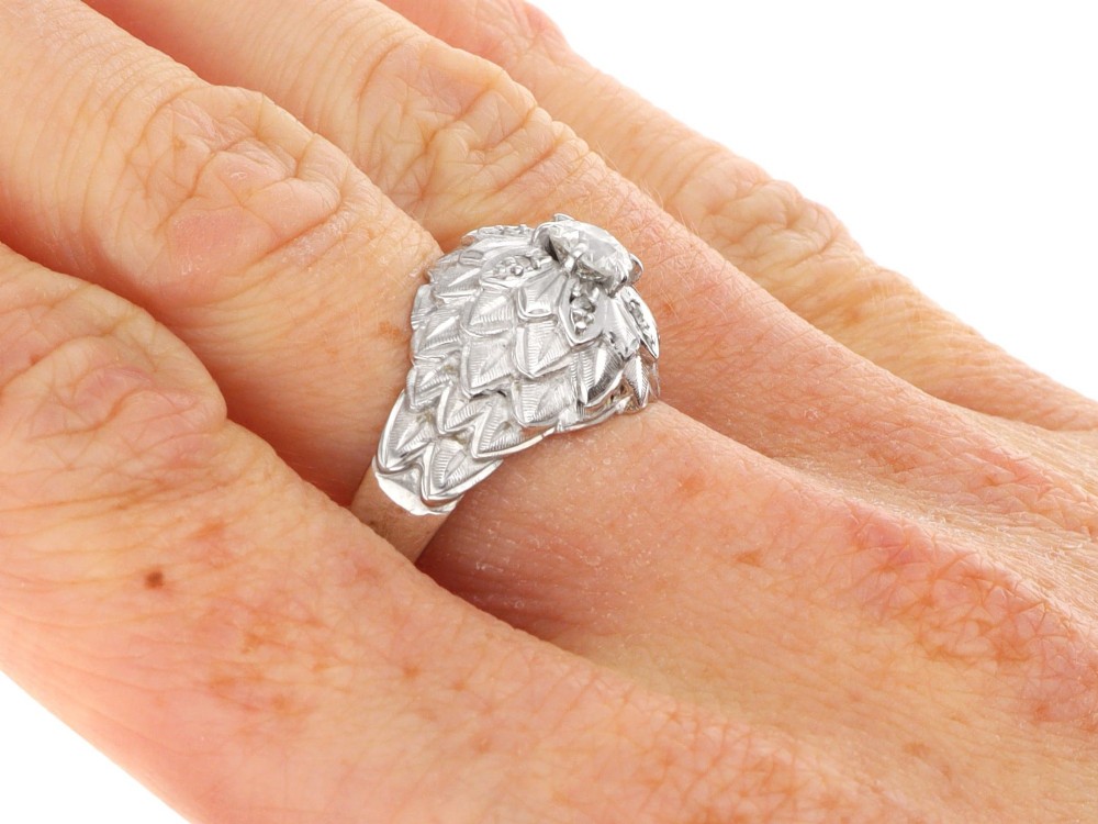 An Art Deco 18ct white gold dress ring with engraved floral textured petals and a central diamond accent. View XI