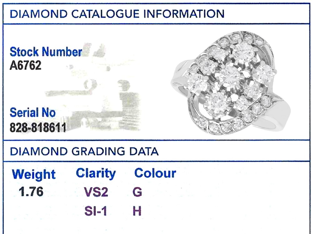 A vintage 1950s 14ct white gold dress ring featuring a multi-diamond cluster and curved accent bands. View IX