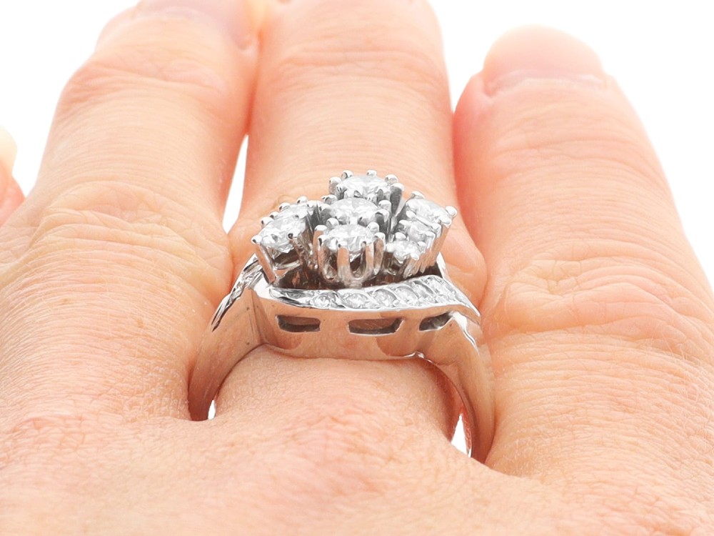 A vintage 1950s 14ct white gold dress ring featuring a multi-diamond cluster and curved accent bands. View XII