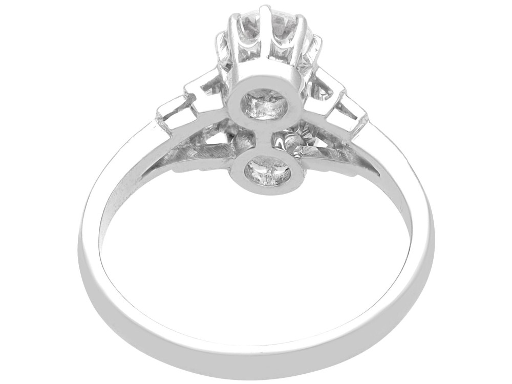 An Art Deco 18ct white gold two-stone diamond ring with stepped baguette cut diamond shoulders. View VI