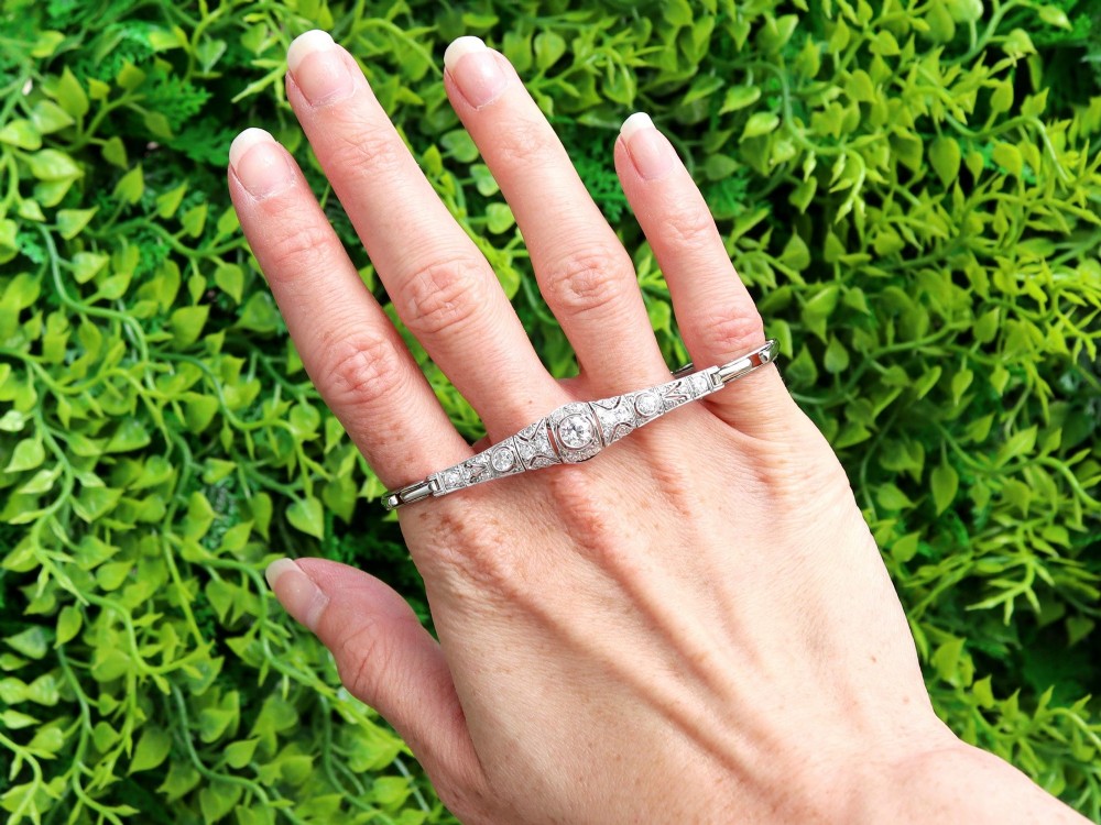 An Art Deco 18ct white gold bracelet featuring articulated geometric panels set with diamonds and finished with millegrain edging. View II