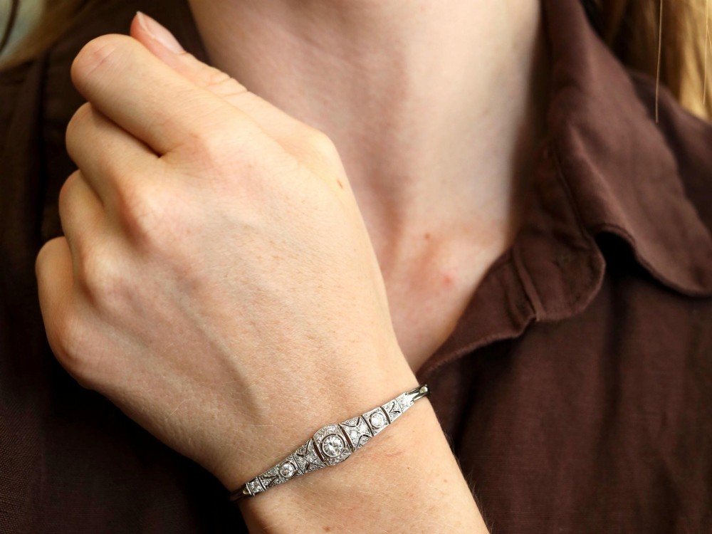 An Art Deco 18ct white gold bracelet featuring articulated geometric panels set with diamonds and finished with millegrain edging. View III