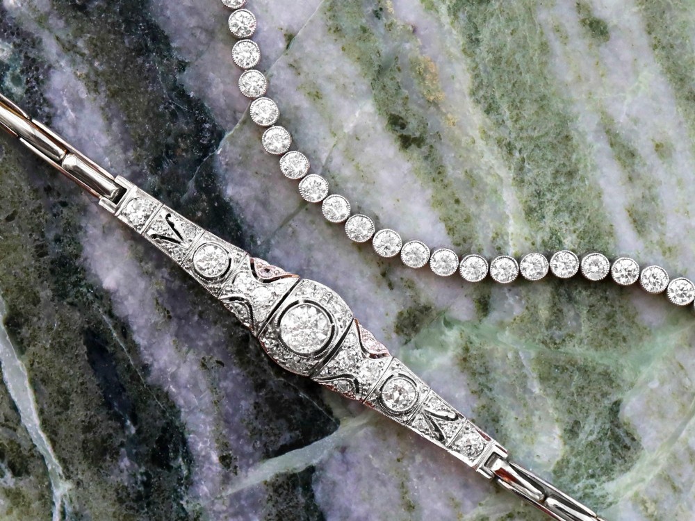 An Art Deco 18ct white gold bracelet featuring articulated geometric panels set with diamonds and finished with millegrain edging. View V
