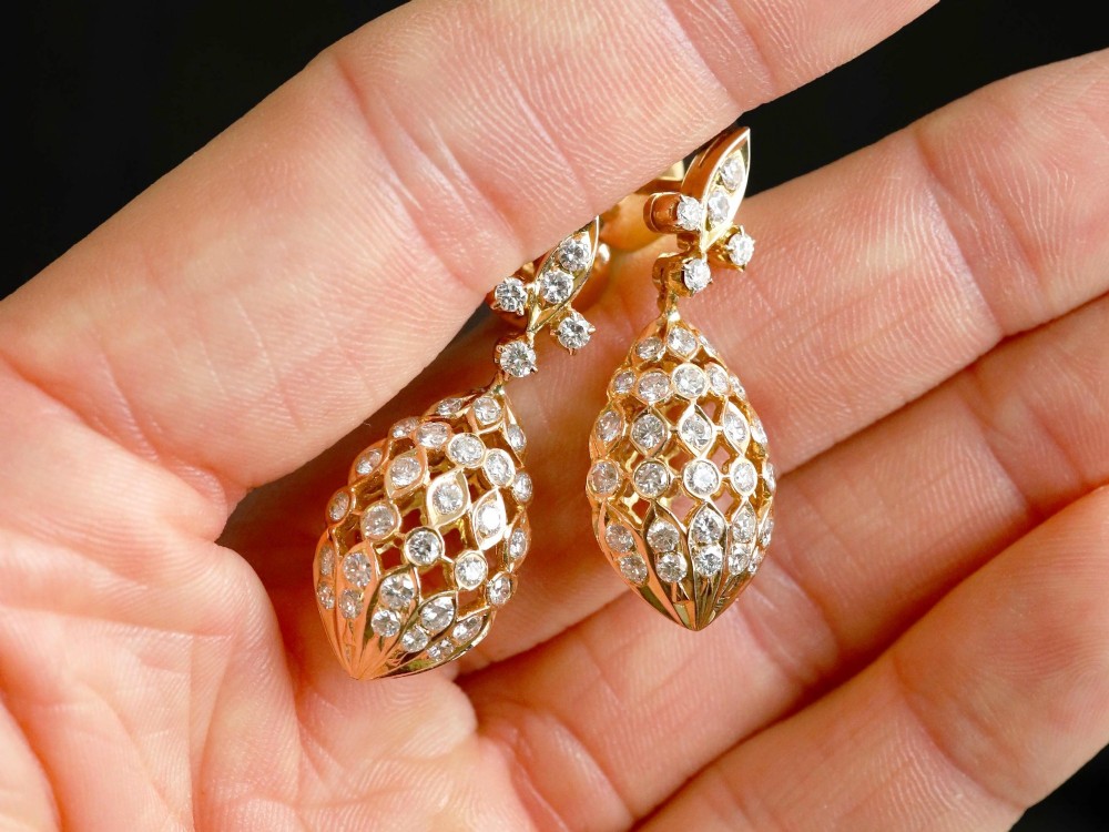 A pair of 18ct yellow gold drop earrings featuring fleur-de-lis surmounts above openwork teardrop cages set with round diamonds. View III
