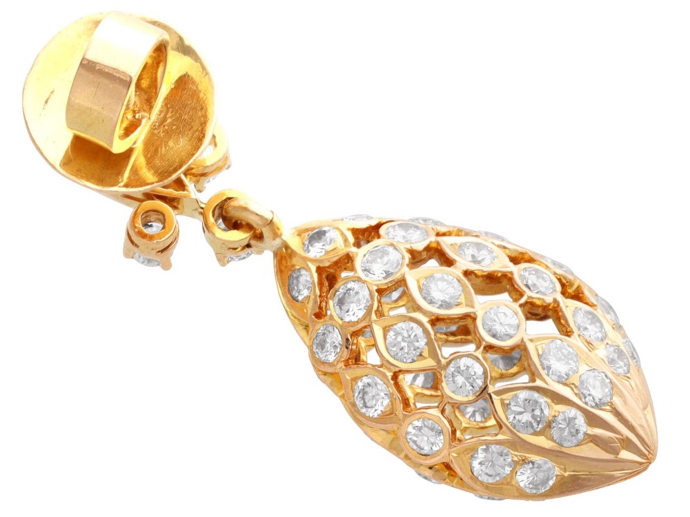 A pair of 18ct yellow gold drop earrings featuring fleur-de-lis surmounts above openwork teardrop cages set with round diamonds. View VIII