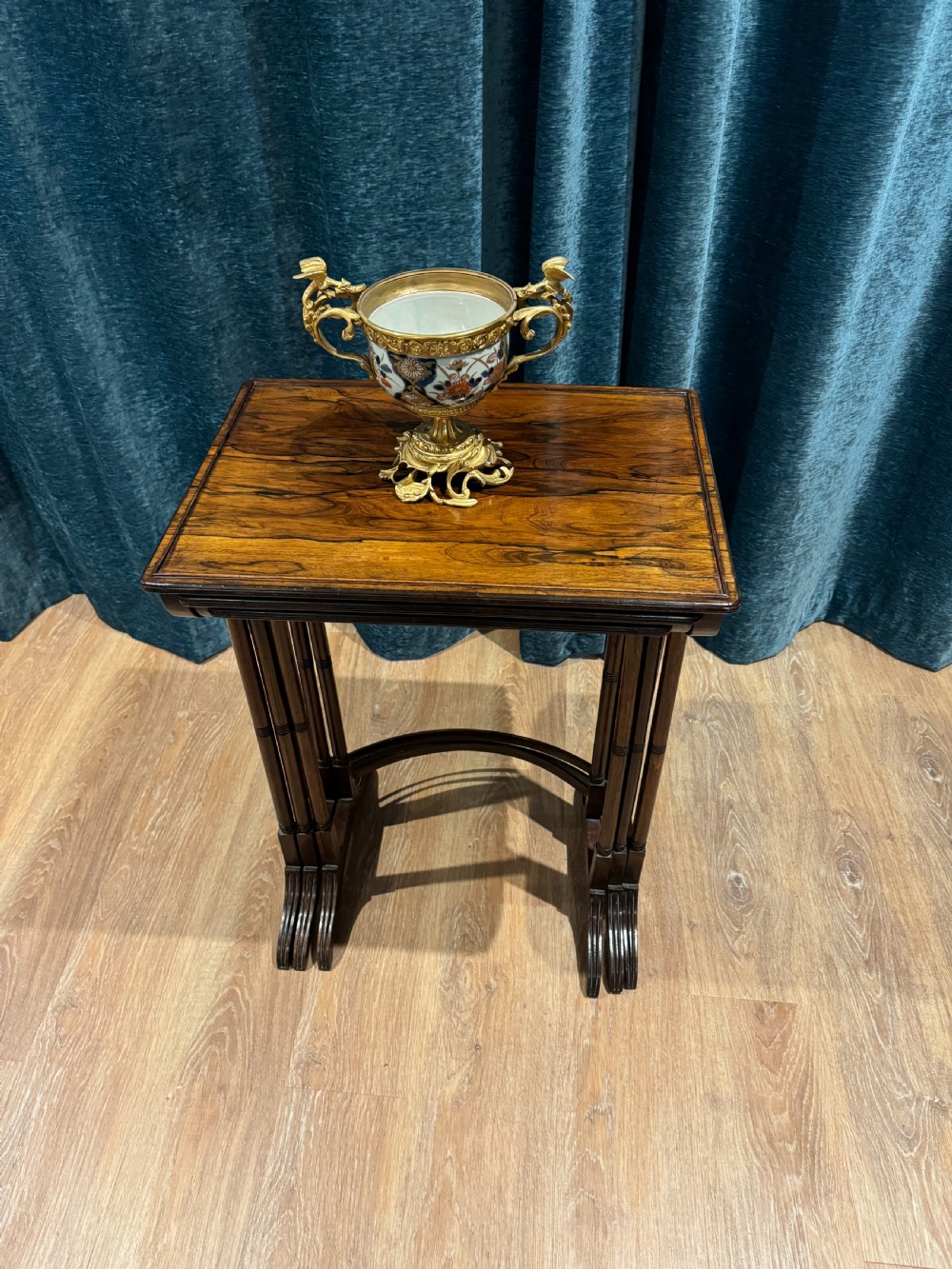 A set of three graduated Regency rosewood nesting side tables with slender turned legs and curved stretchers. View II