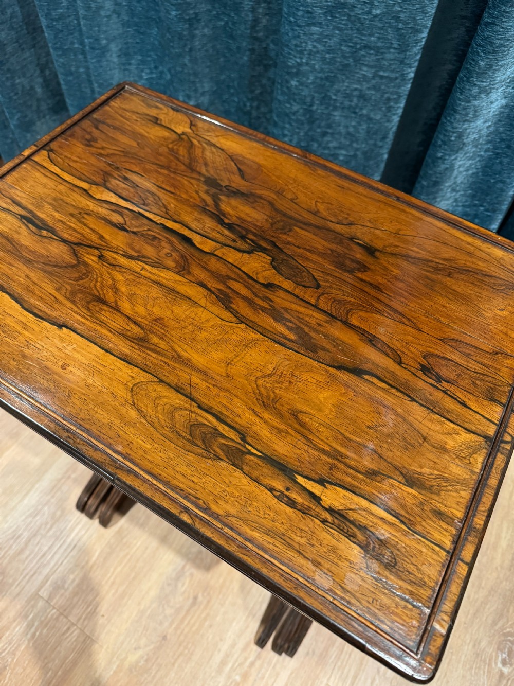 A set of three graduated Regency rosewood nesting side tables with slender turned legs and curved stretchers. View III