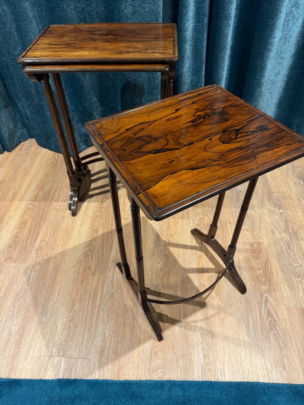 A set of three graduated Regency rosewood nesting side tables with slender turned legs and curved stretchers. View IV