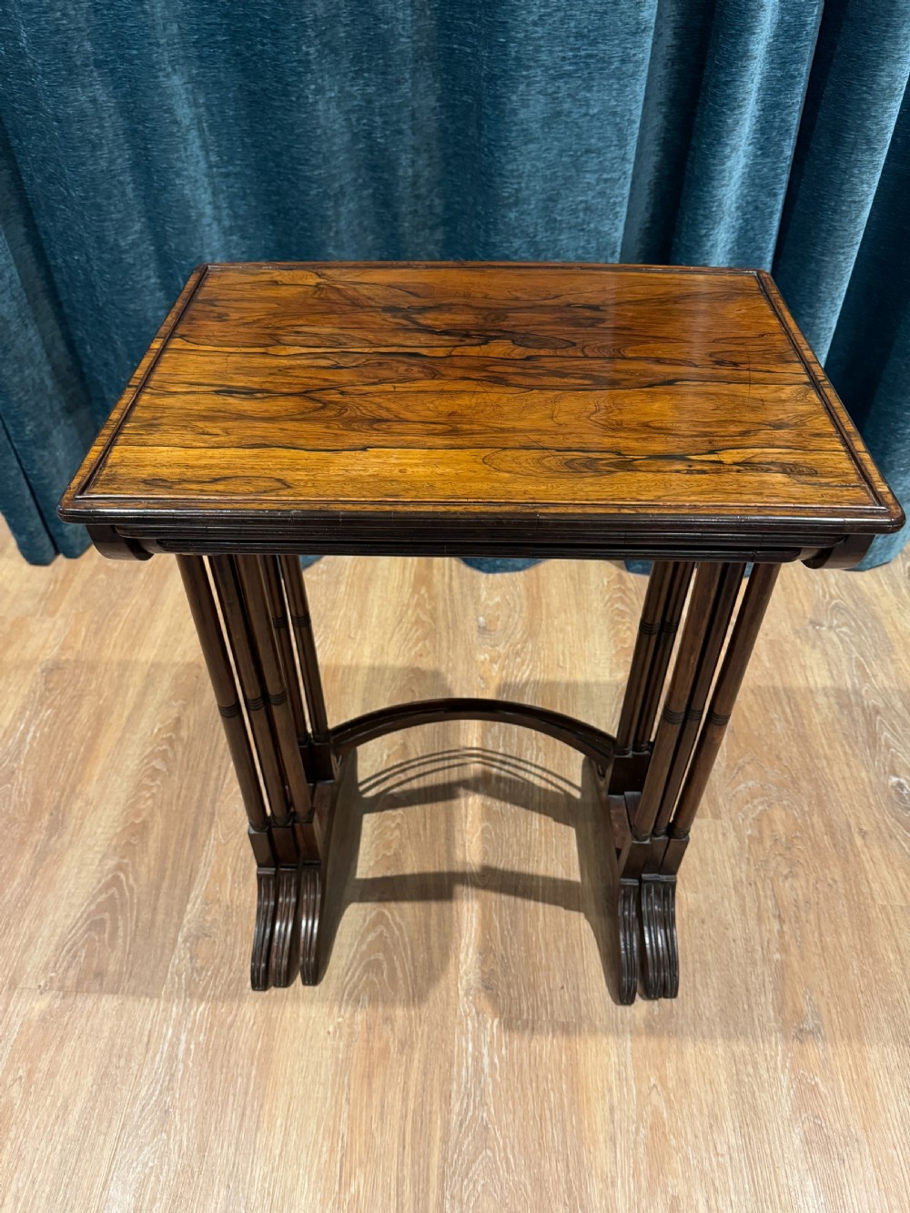 A set of three graduated Regency rosewood nesting side tables with slender turned legs and curved stretchers. View VIII