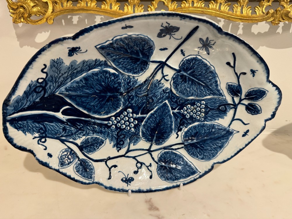 A pair of oval 18th-century English Bow porcelain serving dishes decorated with underglaze blue vine leaves, grapes, and insects. View III