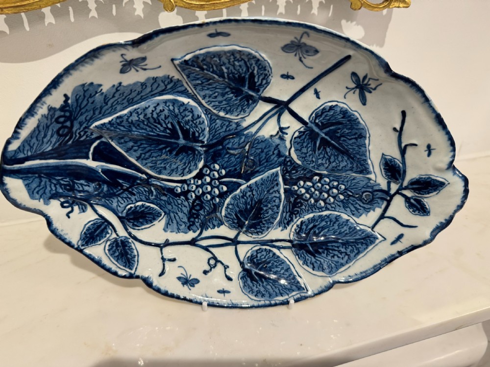 A pair of oval 18th-century English Bow porcelain serving dishes decorated with underglaze blue vine leaves, grapes, and insects. View IV