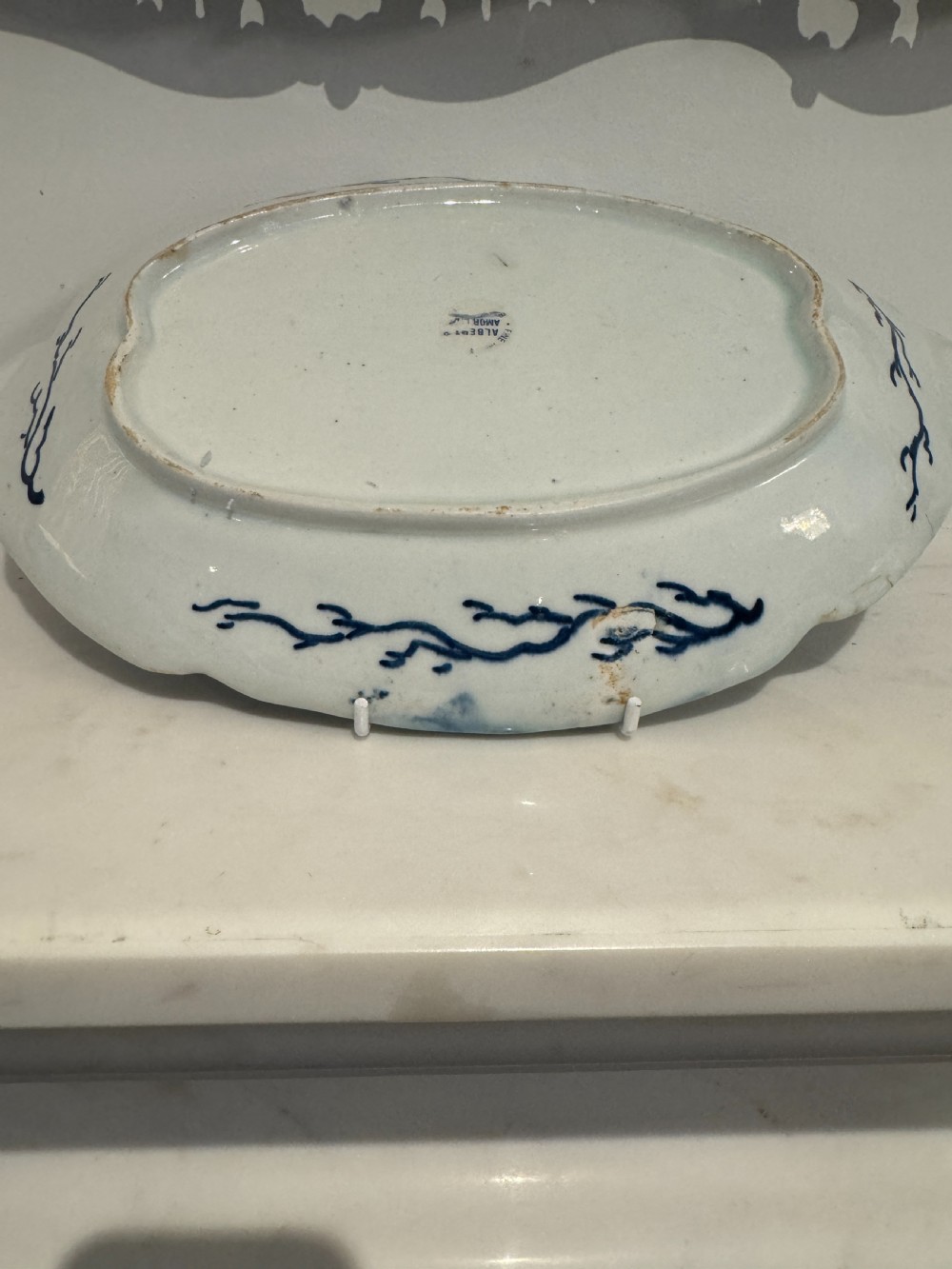 A pair of oval 18th-century English Bow porcelain serving dishes decorated with underglaze blue vine leaves, grapes, and insects. View V