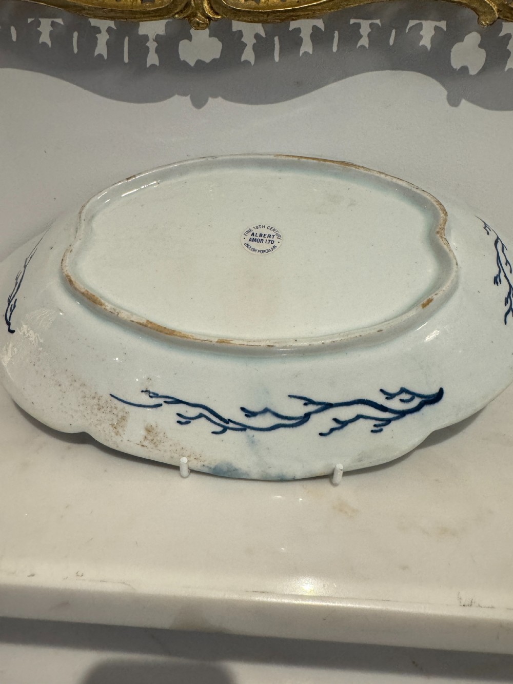 A pair of oval 18th-century English Bow porcelain serving dishes decorated with underglaze blue vine leaves, grapes, and insects. View VI