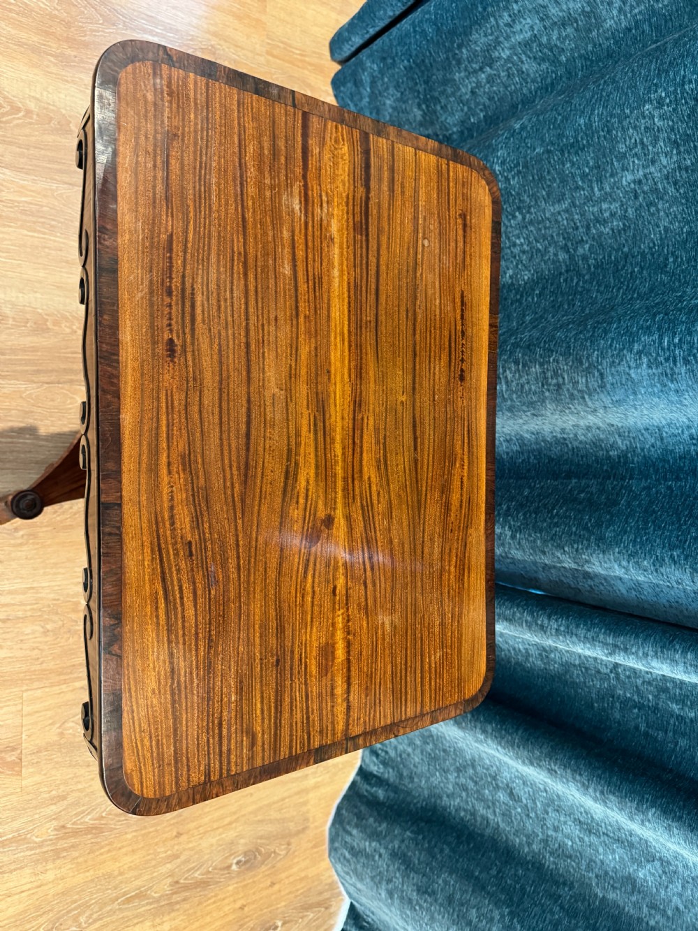 A Regency rosewood side table featuring a crossbanded rectangular top, a carved scrolled apron, and a central pedestal column supported by a triform base on scroll feet. View III