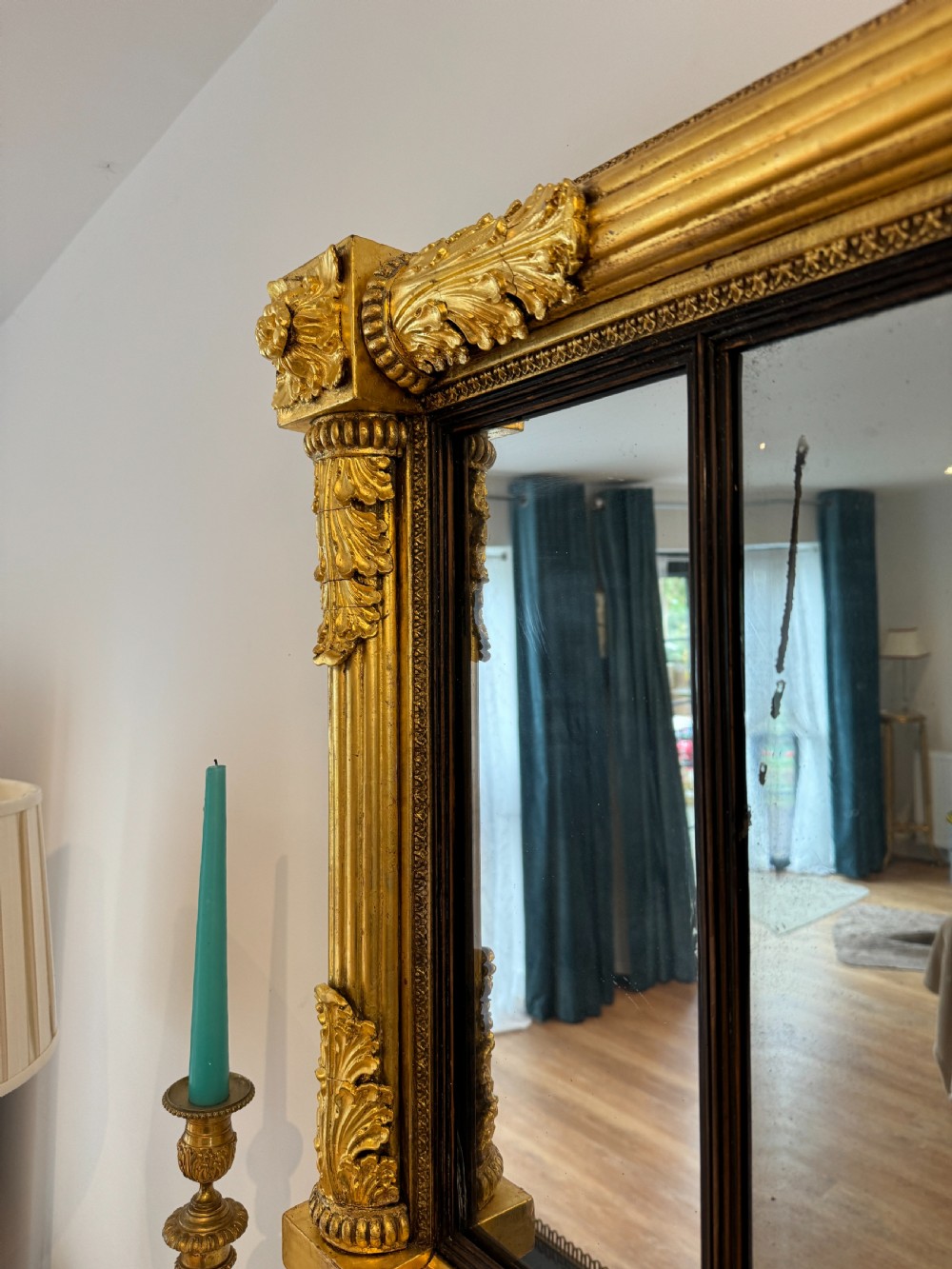A wide Regency giltwood tripartite overmantel mirror featuring side fluted columns and carved leaf accents. View VI