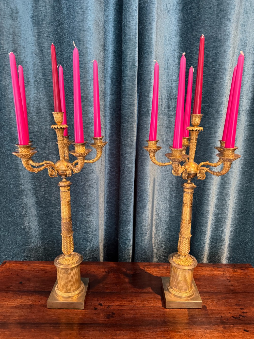 A pair of French Empire ormolu five-branch candelabra featuring intricate engine-turned decoration and square plinth bases. View X