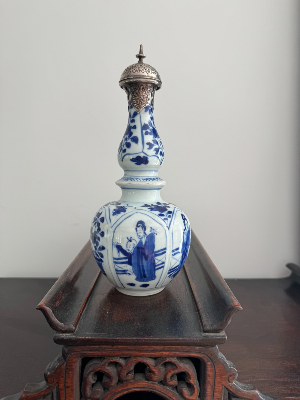 A Chinese Kangxi period underglaze blue and white porcelain vase decorated with figural panels and topped with an engraved silver Islamic mount. View II
