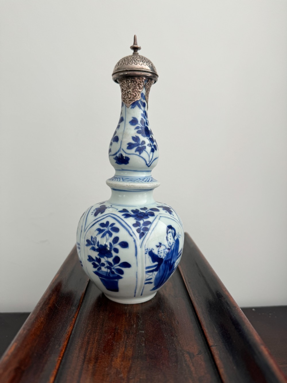 A Chinese Kangxi period underglaze blue and white porcelain vase decorated with figural panels and topped with an engraved silver Islamic mount. View III