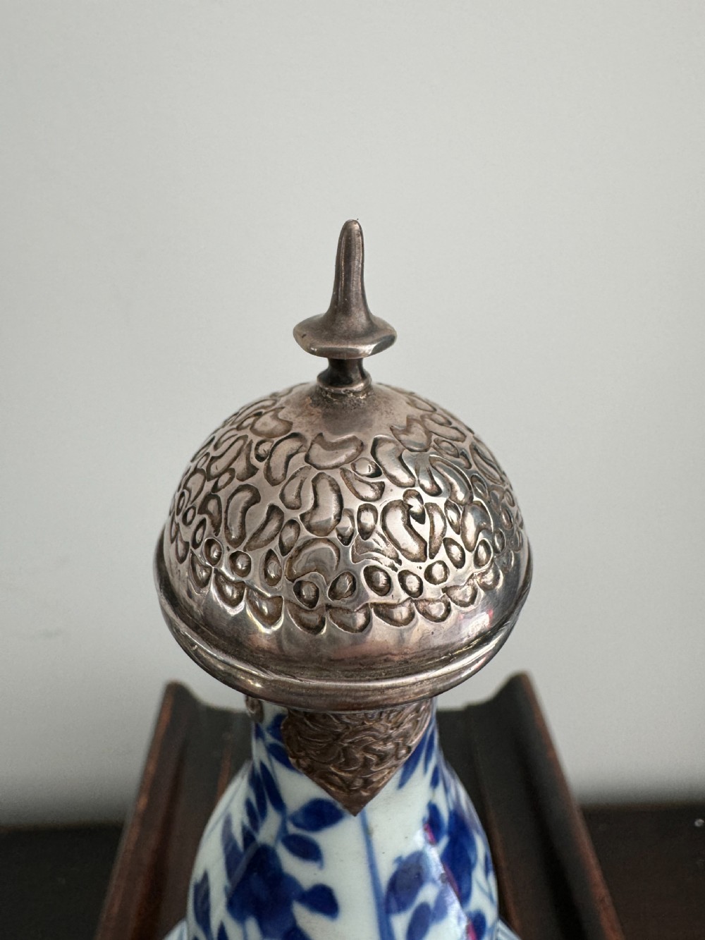 A Chinese Kangxi period underglaze blue and white porcelain vase decorated with figural panels and topped with an engraved silver Islamic mount. View V