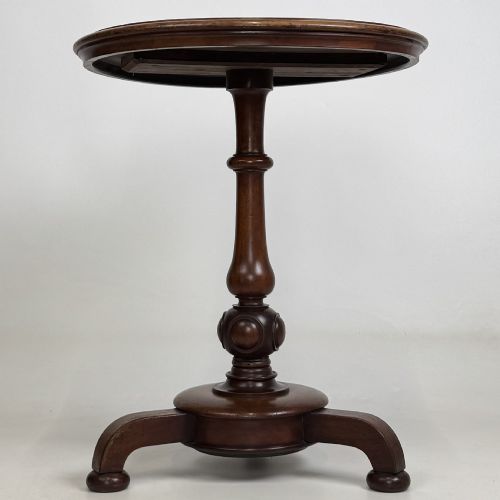 fig 1. A 19th-century Victorian mahogany side table featuring a moulded circular top set upon a central turned pedestal and a four-footed base.