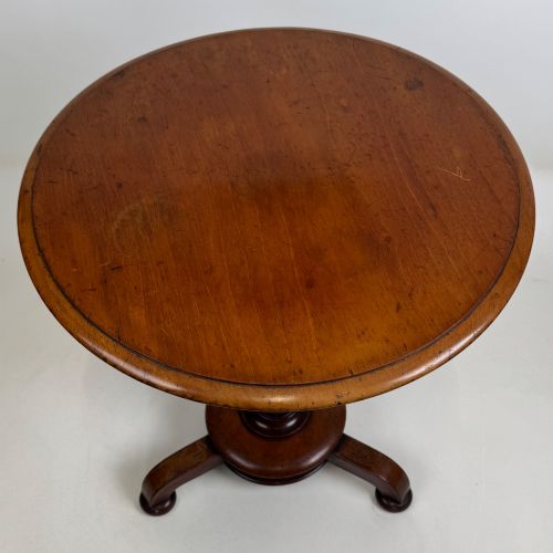 fig 2. A 19th-century Victorian mahogany side table featuring a moulded circular top set upon a central turned pedestal and a four-footed base.