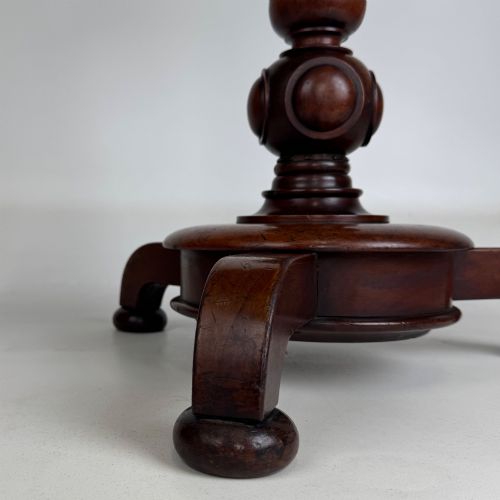 fig 4. A 19th-century Victorian mahogany side table featuring a moulded circular top set upon a central turned pedestal and a four-footed base.