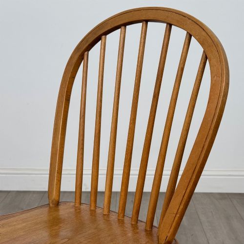 fig 3. A set of six light warm brown ash Windsor dining chairs featuring hoop backs, turned spindles, shaped wooden seats, and turned legs with stretchers.