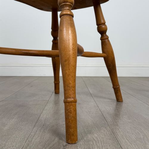 fig 5. A set of six light warm brown ash Windsor dining chairs featuring hoop backs, turned spindles, shaped wooden seats, and turned legs with stretchers.