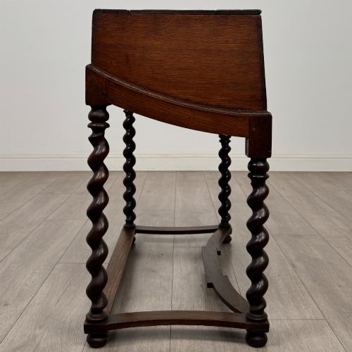 fig 6. A 19th-century dark oak box on a wooden stand featuring four spiral barley twist legs and a central brass keyhole escutcheon.