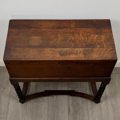 fig 8. A 19th-century dark oak box on a wooden stand featuring four spiral barley twist legs and a central brass keyhole escutcheon.