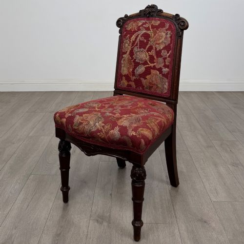 fig 1. A set of six antique 19th-century Victorian oak dining chairs featuring carved crest rails and red patterned fabric upholstery.